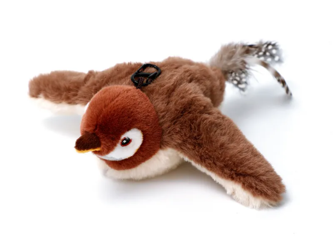 Brown bird-shaped plush with outstretched wings, a white face and belly, and a dark beak and tail details.